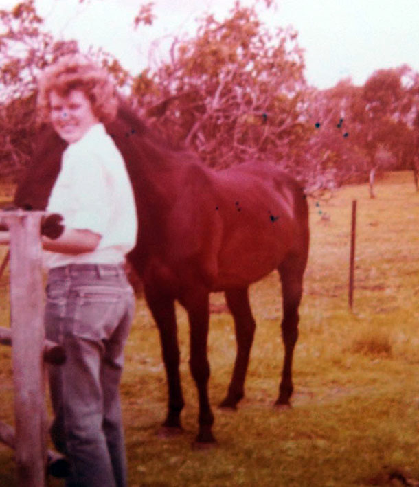 Artist feeding her horse